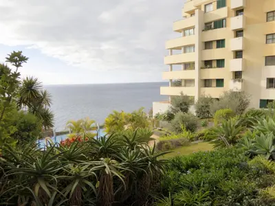 an overhead view of a swimming pool next to the water at Superior Rentals - Beachfront Penthouse in Funchal