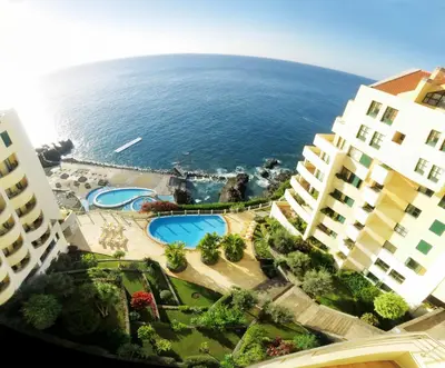 an aerial view of the ocean between two buildings at Superior Rentals - Beachfront Penthouse in Funchal
