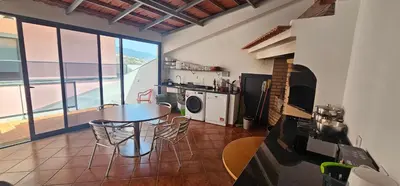 a kitchen with a table and chairs in a room at Peaceful Valley house in Câmara de Lobos
