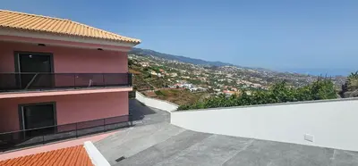 a balcony of a building with a view of a city at Peaceful Valley house in Câmara de Lobos