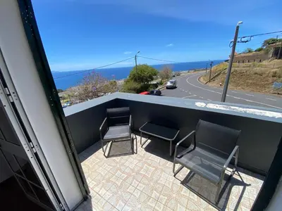 a balcony with chairs and a view of the ocean at Casa a Torre in Santa Cruz