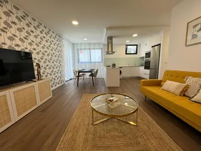a living room with a yellow couch and a table at Stay In Virtudes I in Funchal