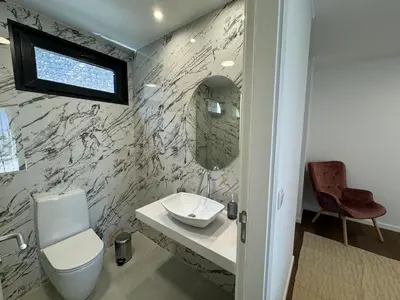 a bathroom with a sink and a toilet and a mirror at Stay In Virtudes I in Funchal