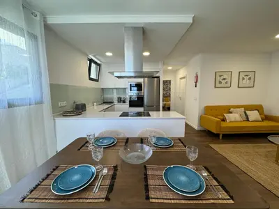a dining table with blue plates on it in a living room at Stay In Virtudes I in Funchal