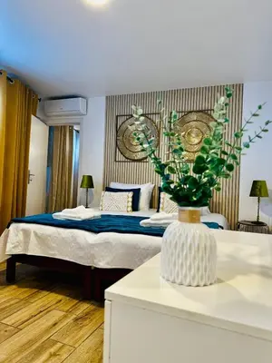 a bedroom with a bed and a vase with a plant at Cantinho das Pedras in Funchal