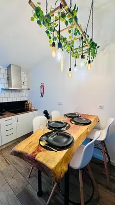a kitchen with a wooden table with plates on it at Cantinho das Pedras in Funchal
