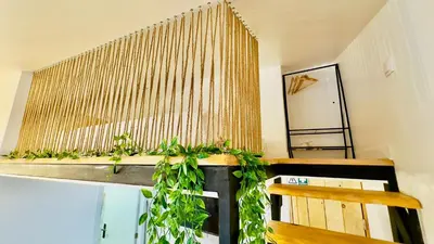 a room with a bench and a window with plants at Cantinho das Pedras in Funchal