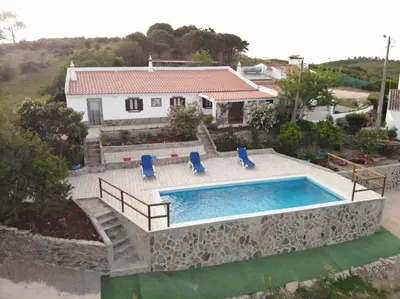 a villa with a swimming pool and a house at Beautiful house in Costa Vicentina in Chabouco