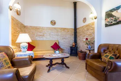 a living room with a couch and a table at Beautiful house in Costa Vicentina in Chabouco