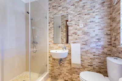a bathroom with a toilet and a sink and a shower at Beautiful house in Costa Vicentina in Chabouco