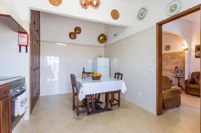 a kitchen with a table and chairs in a room at Beautiful house in Costa Vicentina in Chabouco