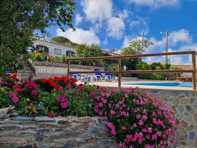 a garden with flowers in front of a house at Beautiful house in Costa Vicentina in Chabouco