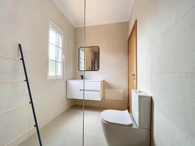 a bathroom with a toilet and a mirror at Moradia Uriel in Santa Cruz