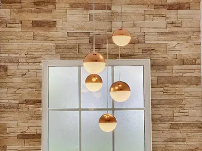 a group of pendant lights hanging over a window at Moradia Uriel in Santa Cruz