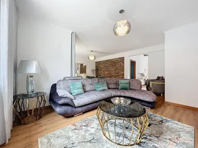 a living room with a couch and a table at Moradia Uriel in Santa Cruz