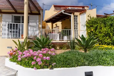 a house with flowers in front of it at Casa das Malvas in Porto Santo