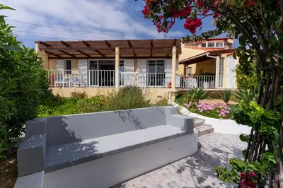 a house with a white bench in front of it at Casa das Malvas in Porto Santo