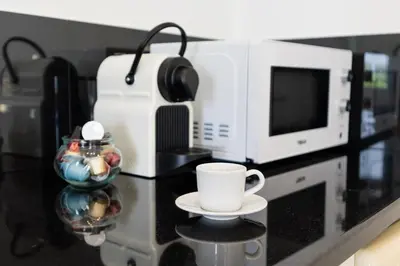 a coffee cup sitting on a counter next to a microwave at Casa das Malvas in Porto Santo