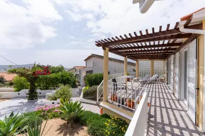a patio with a pergola on a house at Casa das Malvas in Porto Santo