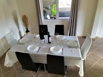 a white table with white chairs and a white table cloth at CASA Bela Vista in Machico