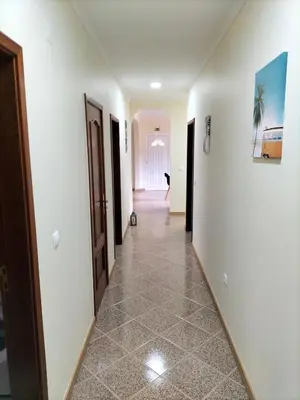 a hallway with white walls and tile floors at CASA Bela Vista in Machico