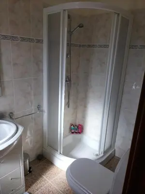 a bathroom with a shower with a toilet and a sink at CASA Bela Vista in Machico