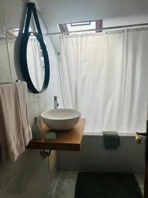 a bathroom with a bowl sink on a wooden table at SOLMAR - Alojamento in Porto Moniz