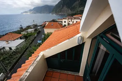 a view of the ocean from the balcony of a building at SOLMAR - Alojamento in Porto Moniz