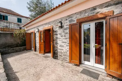 a facade of a house with wooden doors at Casa do Faial in Santana
