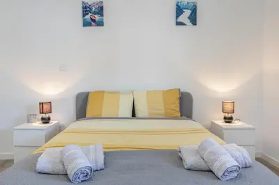 a bedroom with a large bed with two night stands at Maylily Seascape Villa in Santa Cruz