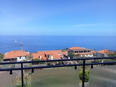 a view of the ocean from a balcony at Lombada Villa Comfort in Ponta Delgada