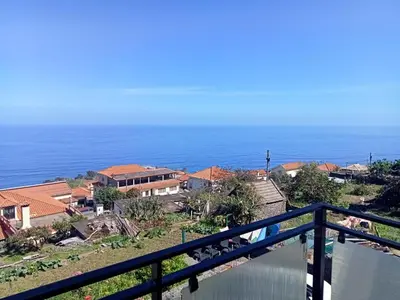 a kitchen with a sink and a washing machine at Lombada Villa Comfort in Ponta Delgada