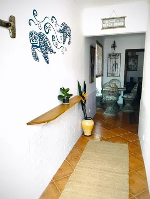 a patio with green grass and chairs and a table at Honu Kai Aloha Home Sagres in Sagres