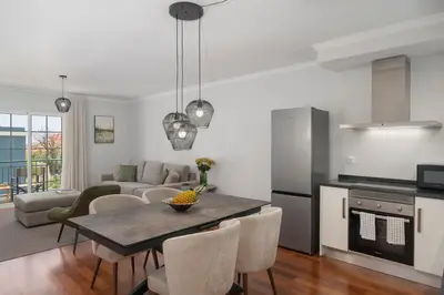 a kitchen and living room with a table and chairs at Santa Cruz II by An Island Apart in Santa Cruz