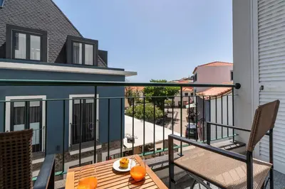 a balcony with a table with oranges on it at Santa Cruz II by An Island Apart in Santa Cruz