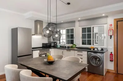 a kitchen with a table with a bowl of fruit on it at Santa Cruz II by An Island Apart in Santa Cruz