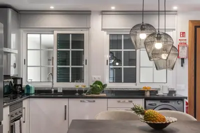 a kitchen with a table with a bowl of fruit on it at Santa Cruz II by An Island Apart in Santa Cruz