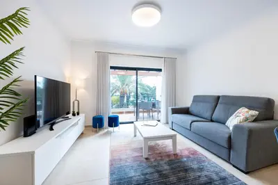 a living room with a couch and a tv at Apartment República in Lagos
