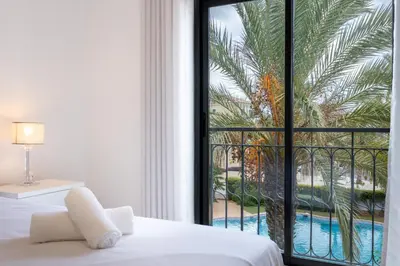 a bedroom with a window with a view of a pool at Apartment República in Lagos