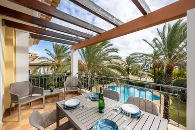 a patio with a table and chairs and a pool at Apartment República in Lagos