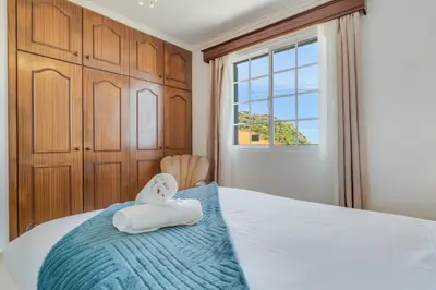 a towel animal sitting on top of a bed at Familia Teixeira House by AH in Arco da Calheta