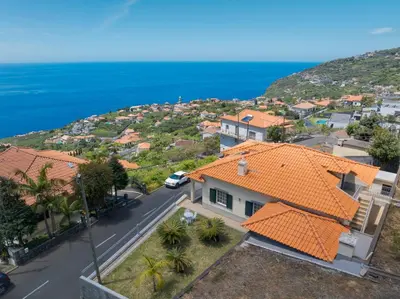 an aerial view of a house with an orange roof at Familia Teixeira House by AH in Arco da Calheta