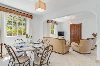 a dining room with a table and chairs at Familia Teixeira House by AH in Arco da Calheta