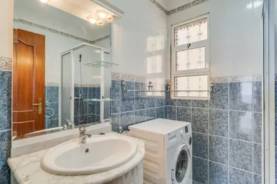 a bathroom with a sink and a washing machine at Familia Teixeira House by AH in Arco da Calheta