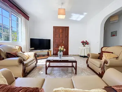 a living room with couches and a tv at Familia Teixeira House by AH in Arco da Calheta
