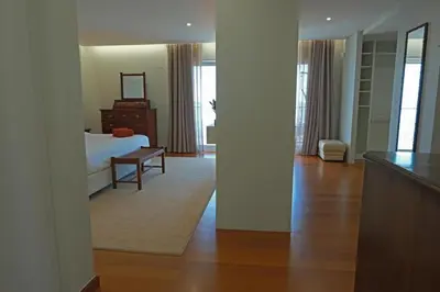 a living room with a bed and a table at Ocean escape with private pool in Arco da Calheta