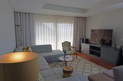 a living room with a couch and a tv at Ocean escape with private pool in Arco da Calheta