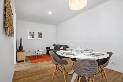 a white dining room with a table and chairs at Casa Bis Bis in Funchal