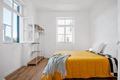 a bedroom with a bed with a yellow blanket at Casa Bis Bis in Funchal