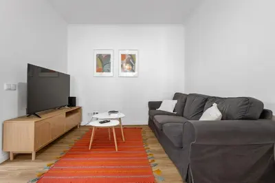 a living room with a couch and a flat screen tv at Casa Bis Bis in Funchal